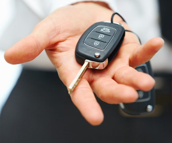 Car Keys. Seller hand giving keys